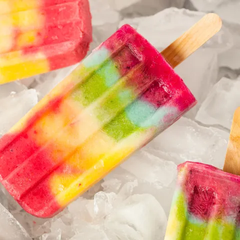 Top view of colorful popsicles on ice