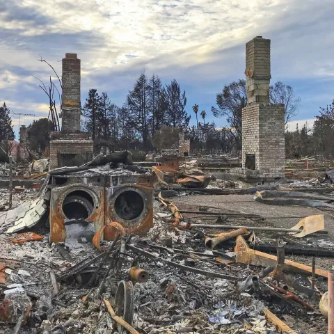 Image with wildfire damages to a house in the wildland-urban interface.