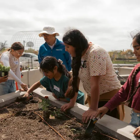 SNAC students and CalFresh Healthy Living staff working on garden