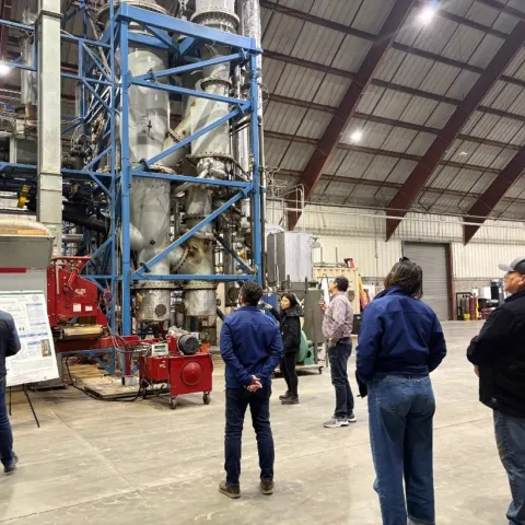 Figure 3. Dr. Li Wang, lead development scientist at the West Biofuels R&D facility, explaining the design of its gasification system