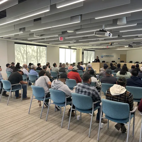 A group of people sitting at a meeting.