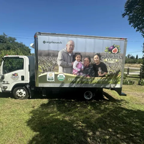 Truck with Angela's Ranch family photo and logo