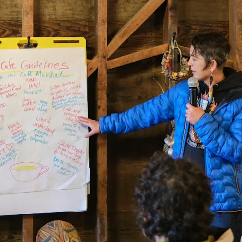 person standing at a flip chart with notes