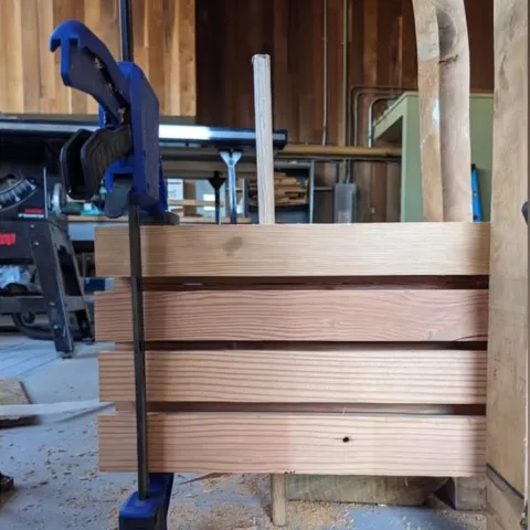 DLT with a dowel inserted through panels of wood