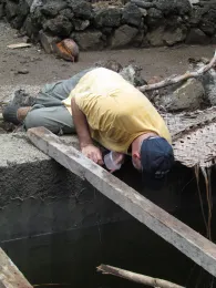 Gregory Lanzaro collecting larvae from cistern, Bouni Comoros