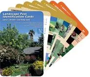 A fan of color-coded Landscape Pest Identification Cards, with a garden photo on the front card.