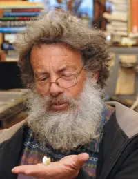 Art Shapiro, distinguished professor of evolution and ecology, holding a cabbage white butterfly. (Photo by Kathy Keatley Garvey)