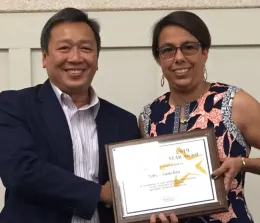 Tu Tran, left, presents Robin Sanchez with her award.