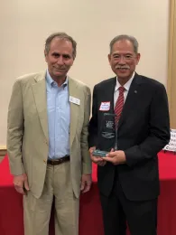 Rick Otis, left, presents award to John Kabashima.