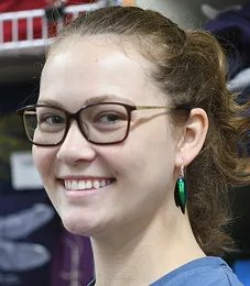 Entomologist Eliza Litsey with beetle earrings on sale at the Bohart Museum. (Photo by Kathy Keatley Garvey)