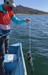 Greg Jesmok deploying a water column sampler at Castaic Lake. Photo by P. Ganguli.