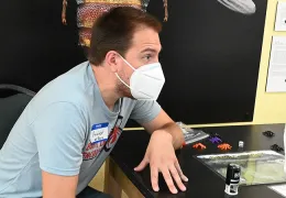 Doctoral student Xavier Zahnle of the Bond lab answers questions at the open house. (Photo by Kathy Keatley Garvey)