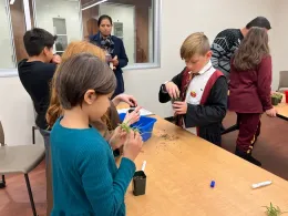 Another set of students pot up their spider plants.