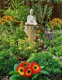 Peaceful wellness garden with buddha statue and flowers