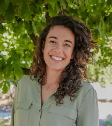 Kelsie headshot in front of leafy tree