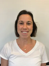 A woman wearing a white shirt, and a white background