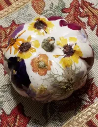 white pumpkin decorated with pressed flowers