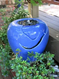 Colorful blue pottery fountain in garden