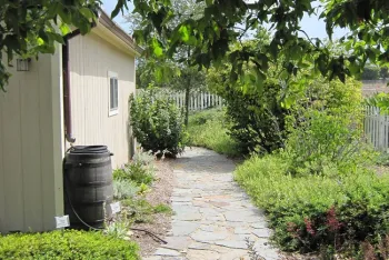 Roof gutter downspout redirection.