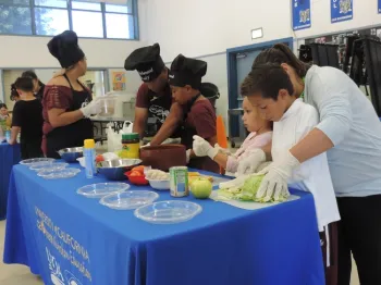 Families making special dishes for judges