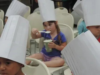 Student taste testing chicken soup
