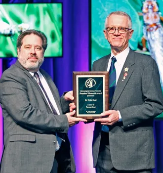 ESA president Bob Peterson presents a plaque to Walter Leal, who delivered the Founder's Memorial Lecture.