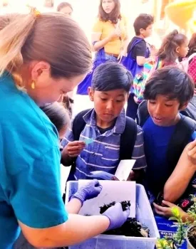 Maggie O'Neill teaching children at a Master Gardeners event.