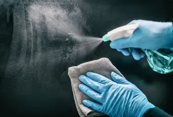 Disinfecting a surface.