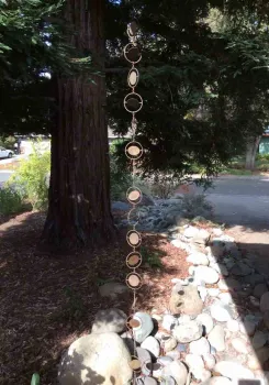 A decorative rain chain at the ‘headwaters' of the creek bed directs flow from the roof gutter.