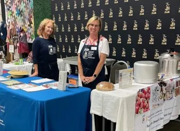 Volunteers at an information table talking with community members
