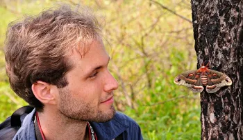 Sam Jaffe, founder and executive director of The Caterpillar Lab, looks at a 