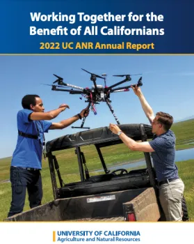 Two guys load a drone into a pickup.