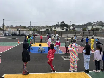 Community Nutrition Educator leading physical activity lesson for children