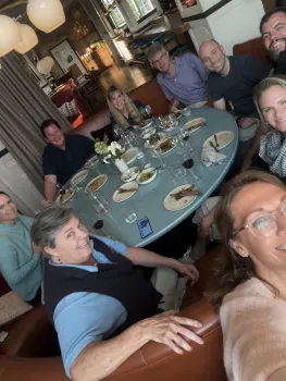 People dining at a round table. Photo shot at an angle