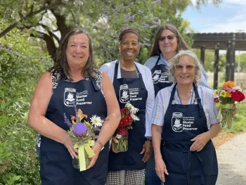Graduating MFP Class of 2025 four women standing in beautiful landscape
