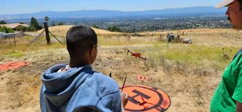 male 4-H youth flying a drone
