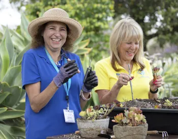 Two Master Gardeners demonstrating potted planting
