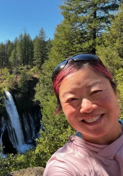 Lydia Tymon selfie with a waterfall behind her
