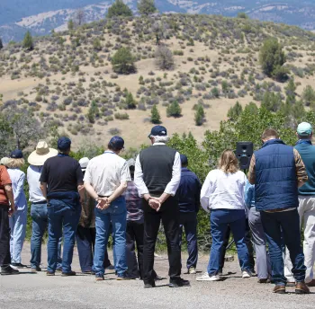 People viewing foothills, trees, and landscaple