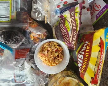 various opened bags and containers of dried fruit,