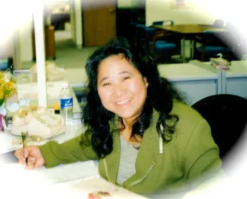 Headshot of Lan sitting at desk