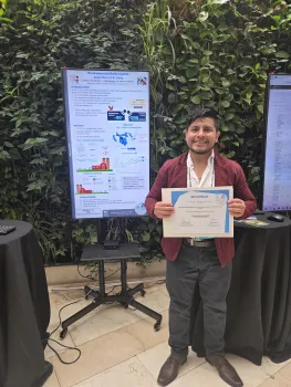 Luis stands next to his poster "The unexpected bttle against avian flu in U.S. dairy. He is holding an IDF certificate