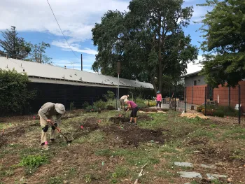 Photo of volunteers working on the layout of the garden.
