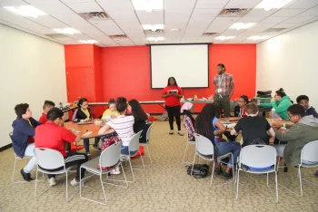 Youth learning at tables