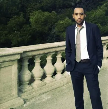 Ahmed Ayoub wearing a dark suit standing outdoors