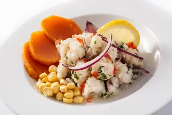 Photo of the dish Ceviche Peruanyo in a bowl with carrots and corn