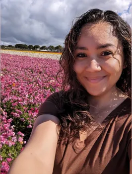 Darlene Ruiz headshot with flower fields behind her