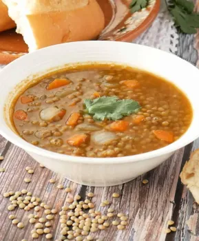 Photo of the this Sopa de Lentejas in a bowl with some bread