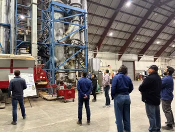 Figure 3. Dr. Li Wang, lead development scientist at the West Biofuels R&D facility, explaining the design of its gasification system