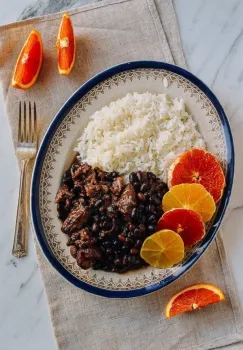 photo of the dish Feijoada and oranges slices on a plate